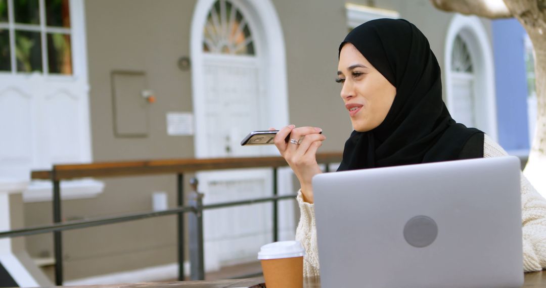 Young Muslim Businesswoman Speaking on Phone in Outdoor Workspace - Free Images, Stock Photos and Pictures on Pikwizard.com