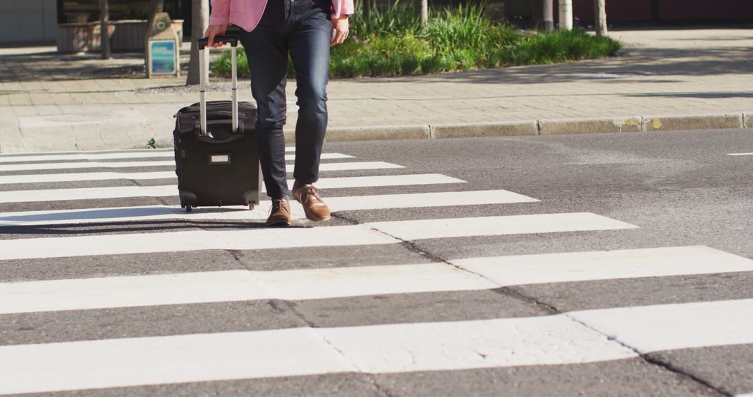 Traveler With Suitcase Crossing Street on Zebra Pedestrian Crossing - Free Images, Stock Photos and Pictures on Pikwizard.com