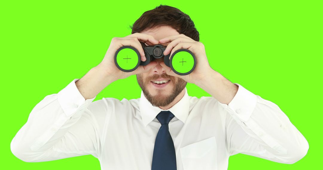 Businessman in White Shirt Looking Through Binoculars Isolated on Green Background - Free Images, Stock Photos and Pictures on Pikwizard.com