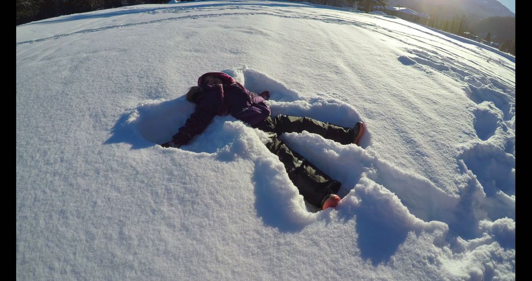 Child Making Snow Angel on Winter's Day - Free Images, Stock Photos and Pictures on Pikwizard.com