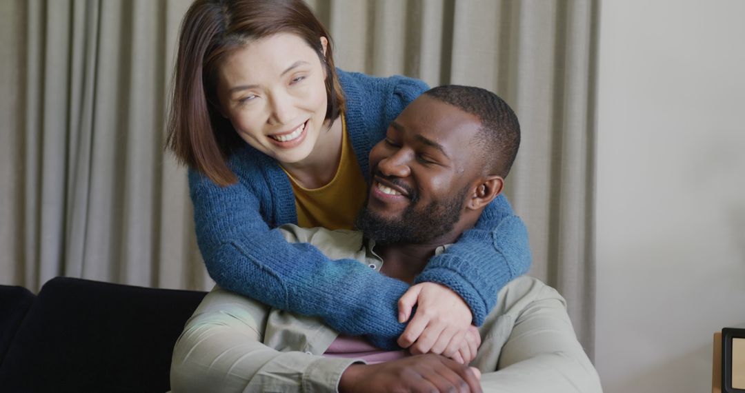 Happy Interracial Couple Embracing at Home - Free Images, Stock Photos and Pictures on Pikwizard.com