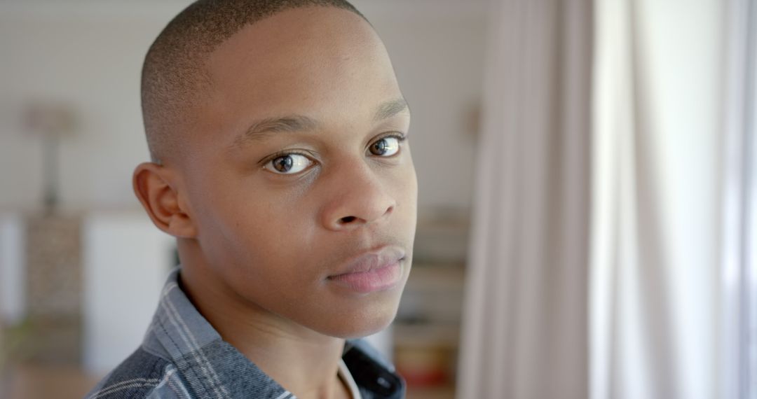 Close-up Portrait of Young African American Man Looking at Camera Indoors - Free Images, Stock Photos and Pictures on Pikwizard.com