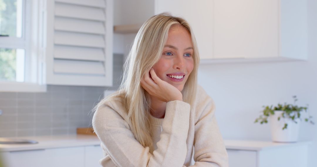 Smiling Woman Relaxing in Bright Modern Kitchen Environment