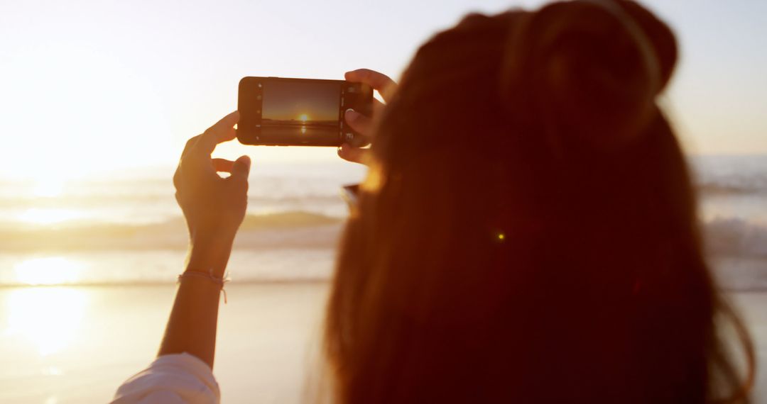 Woman Capturing Sunset on Smartphone at Beach - Free Images, Stock Photos and Pictures on Pikwizard.com