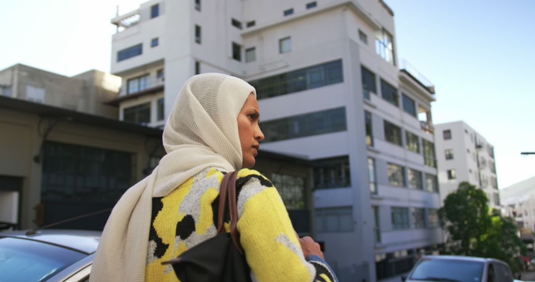 Muslim Woman Walking in Urban Area with Modern Buildings - Free Images, Stock Photos and Pictures on Pikwizard.com