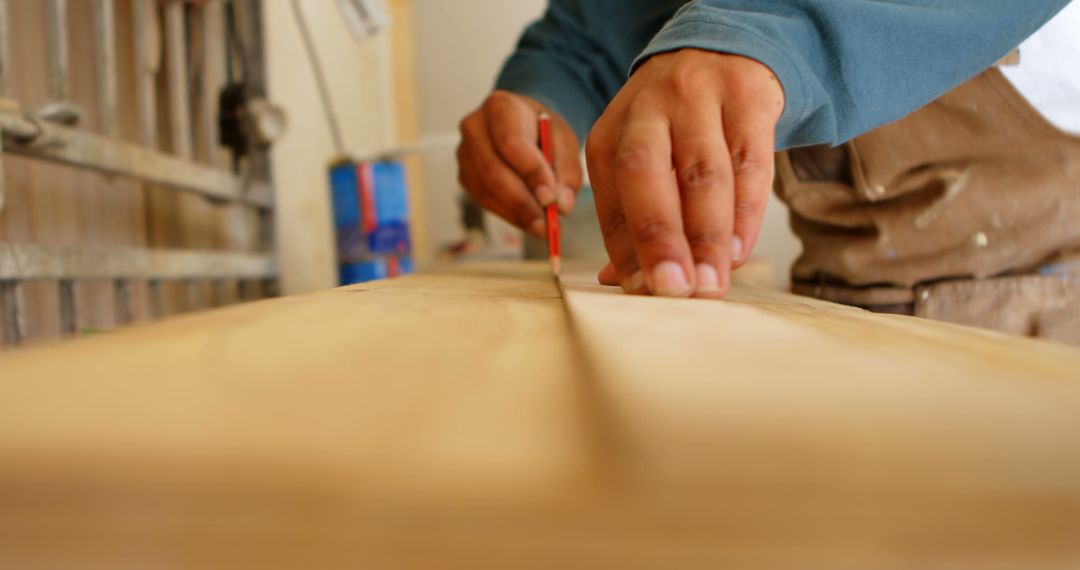 Carpenter Marking Wood Plank with Pencil in Workshop - Free Images, Stock Photos and Pictures on Pikwizard.com