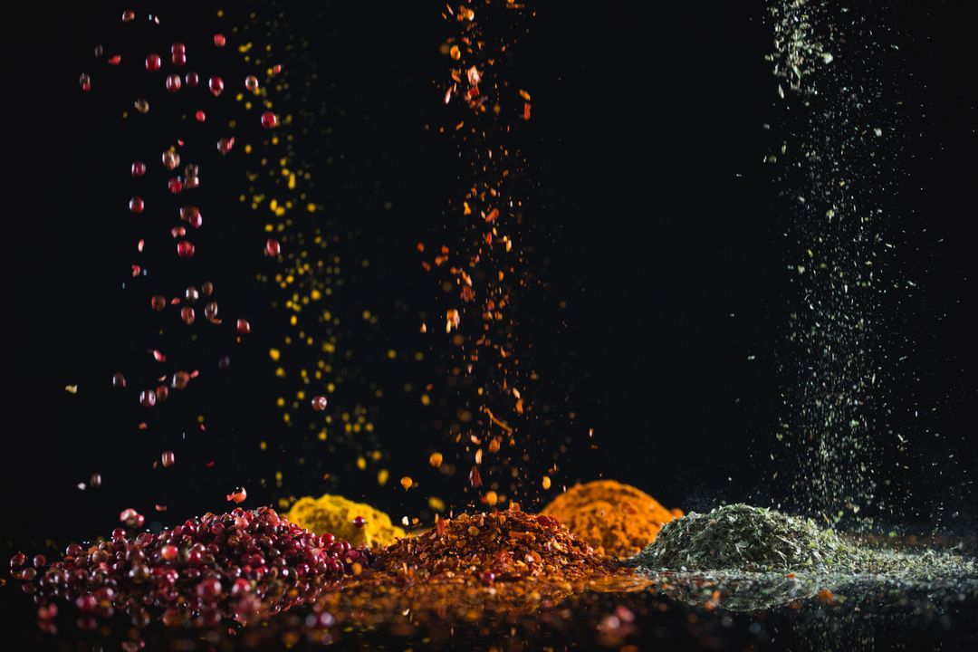 Colorful Spices Falling Against Black Background - Free Images, Stock Photos and Pictures on Pikwizard.com
