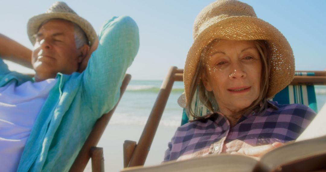 Senior Couple Relaxing and Reading on Beach