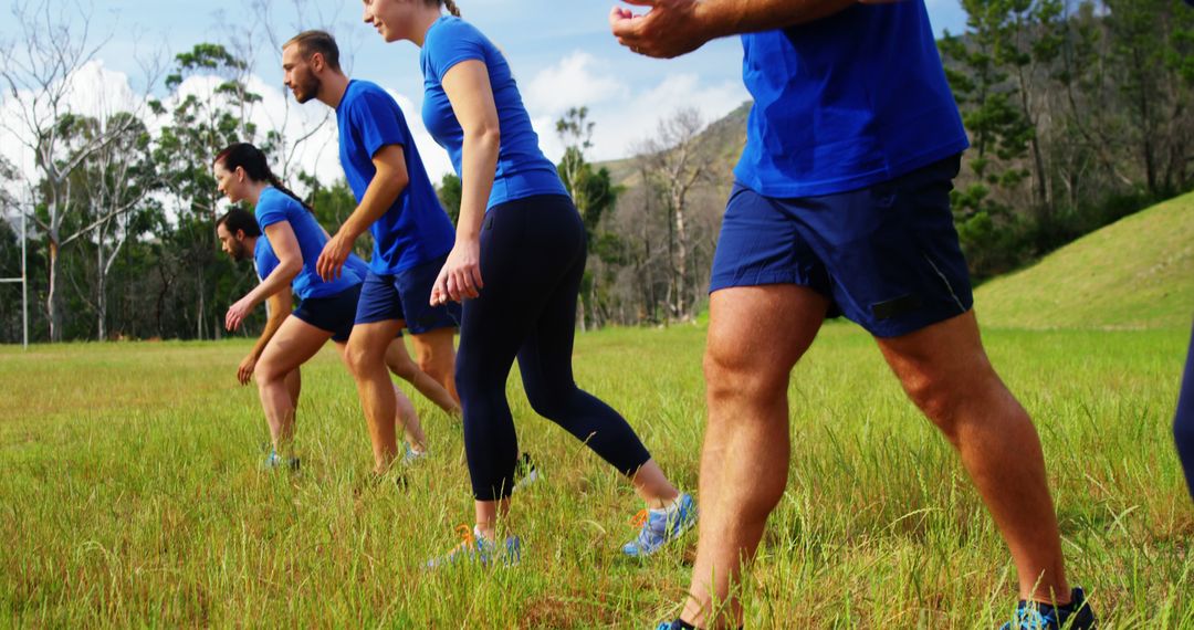 Group of People Exercising Outdoors in Blue Sportswear - Free Images, Stock Photos and Pictures on Pikwizard.com