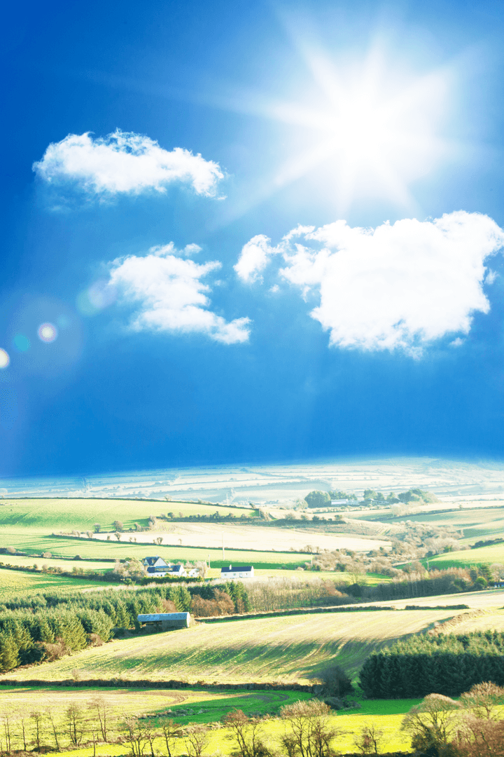 Scenic Landscape of Green Fields under Clear Blue Sky with Shining Sun