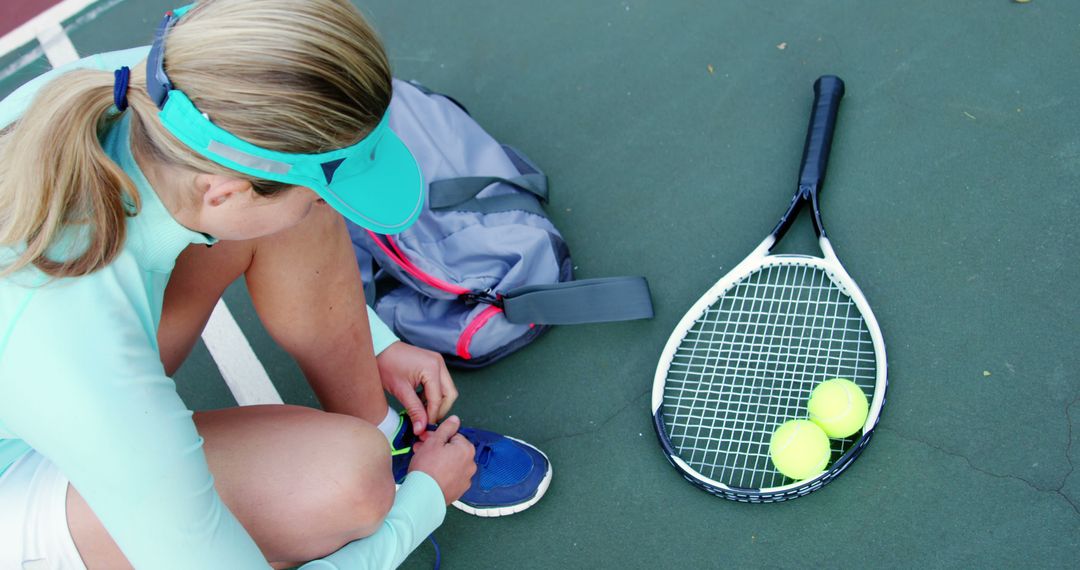 Female Tennis Player Tying Shoe On Tennis Court - Free Images, Stock Photos and Pictures on Pikwizard.com