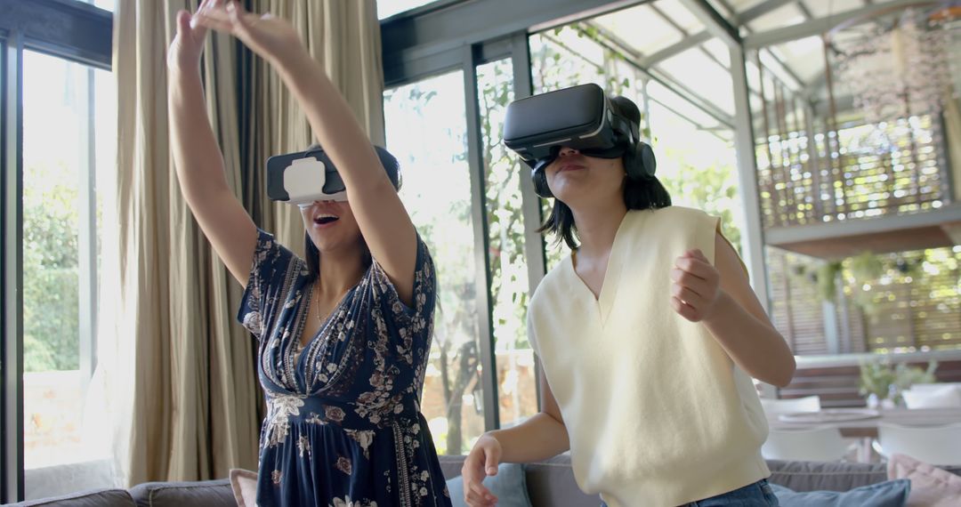 Two Women Enjoying Virtual Reality in Modern Home - Free Images, Stock Photos and Pictures on Pikwizard.com