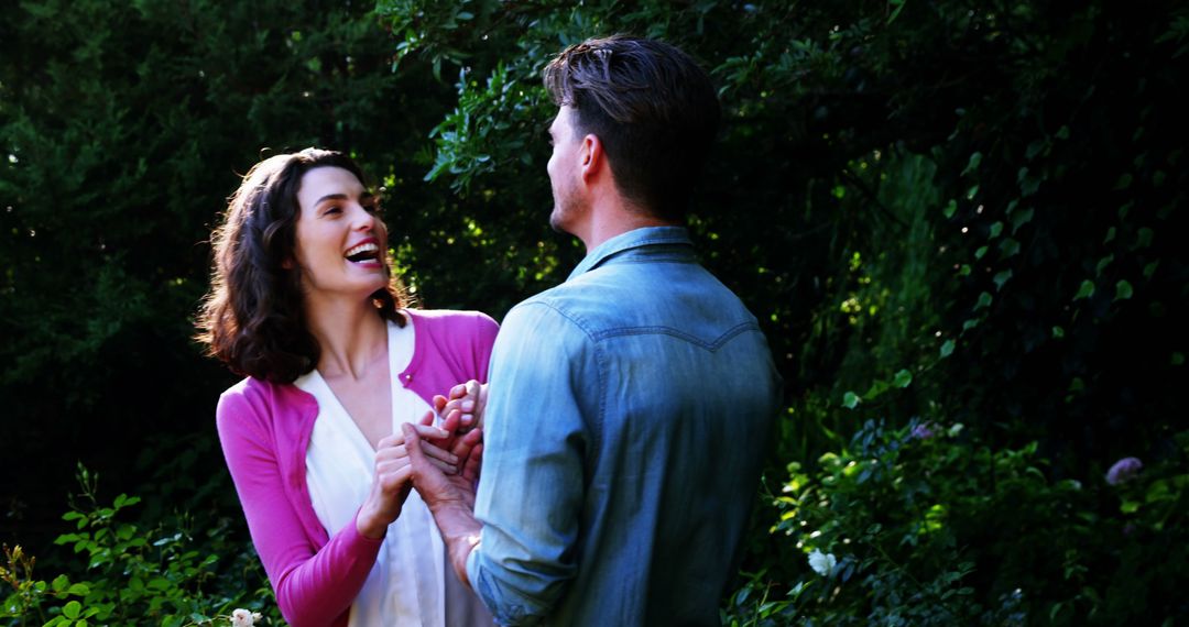 Joyful Couple Laughing in Serene Outdoor Garden