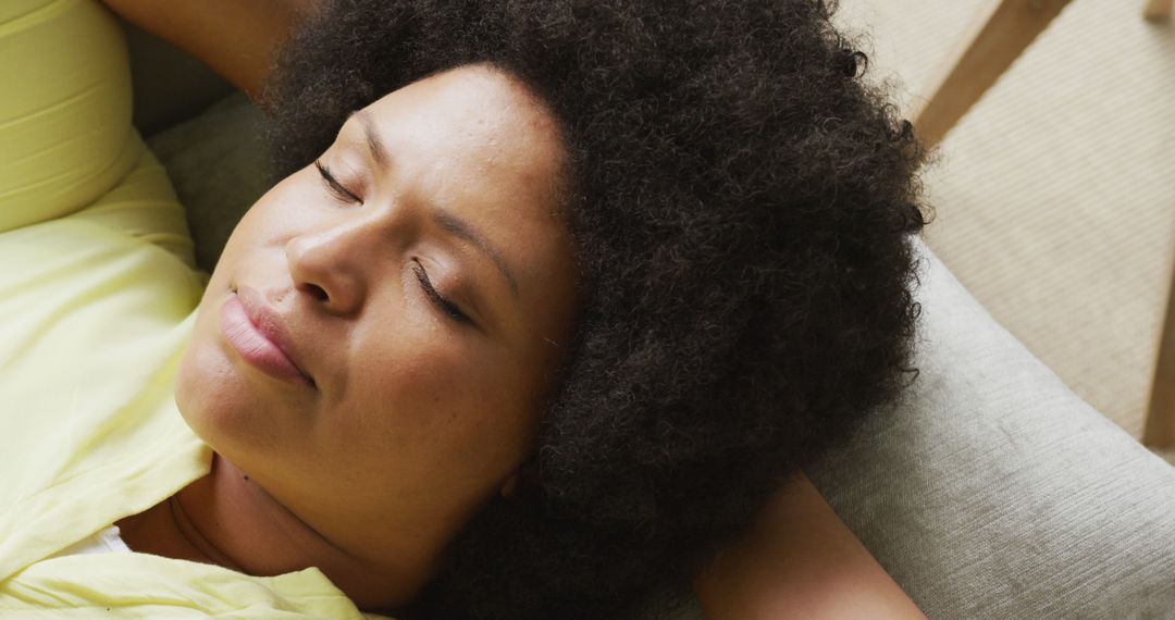 Relaxing Afro-American Woman Resting on Sofa at Home - Free Images, Stock Photos and Pictures on Pikwizard.com