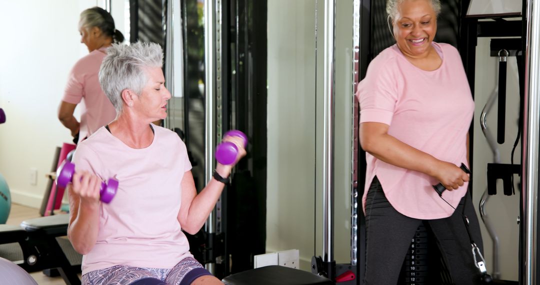 Senior Lesbian Couple Exercising with Weights in Home Gym