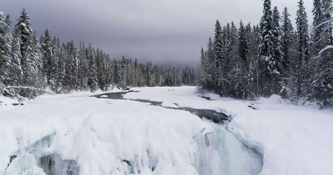 Snow-covered Frozen River with Waterfall in Winter Forest - Free Images, Stock Photos and Pictures on Pikwizard.com