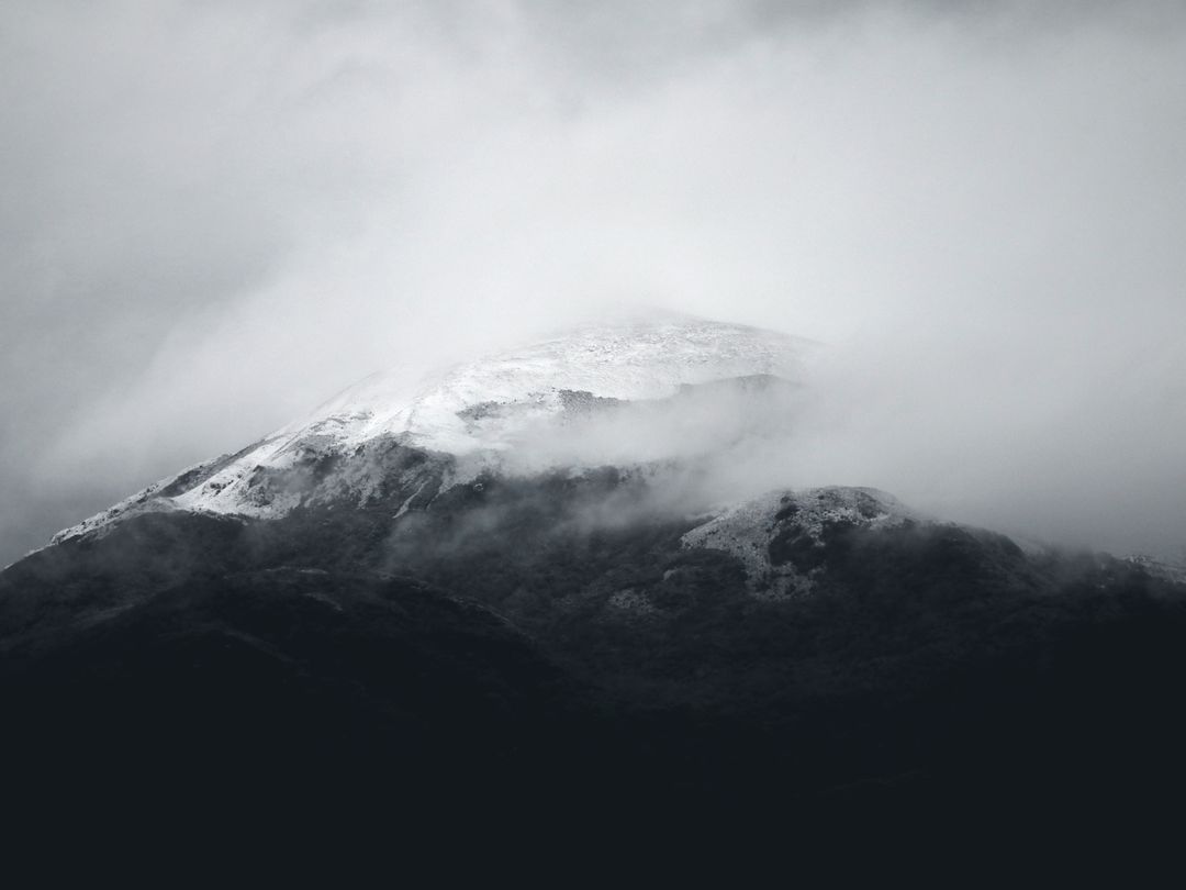 Majestic Snow-Covered Mountain Peak Shrouded in Mist - Free Images, Stock Photos and Pictures on Pikwizard.com