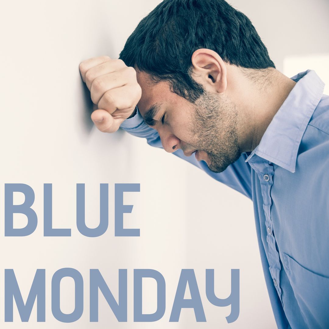 Stressed Man on Blue Monday Leaning Against Wall