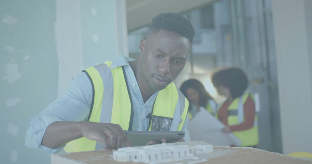 Biracial Engineer Examining 3D Building Model with Concentration