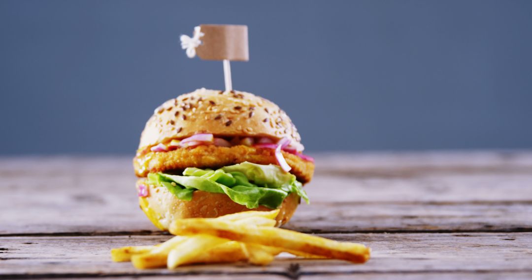 Delicious Crispy Chicken Burger with Fries on Rustic Wooden Table - Free Images, Stock Photos and Pictures on Pikwizard.com