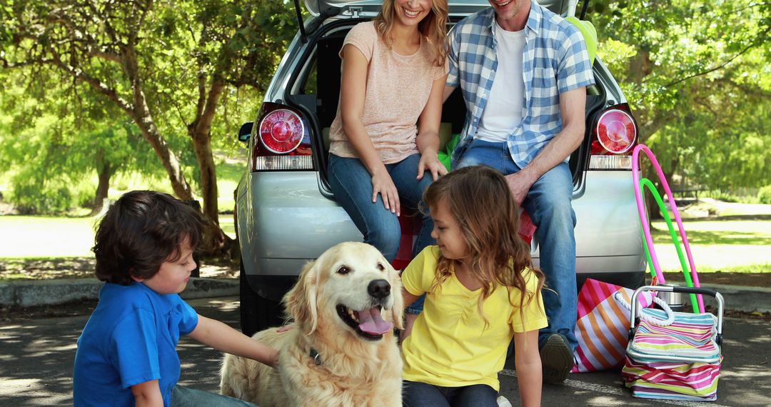 Happy Family with Dog Relaxing in Park