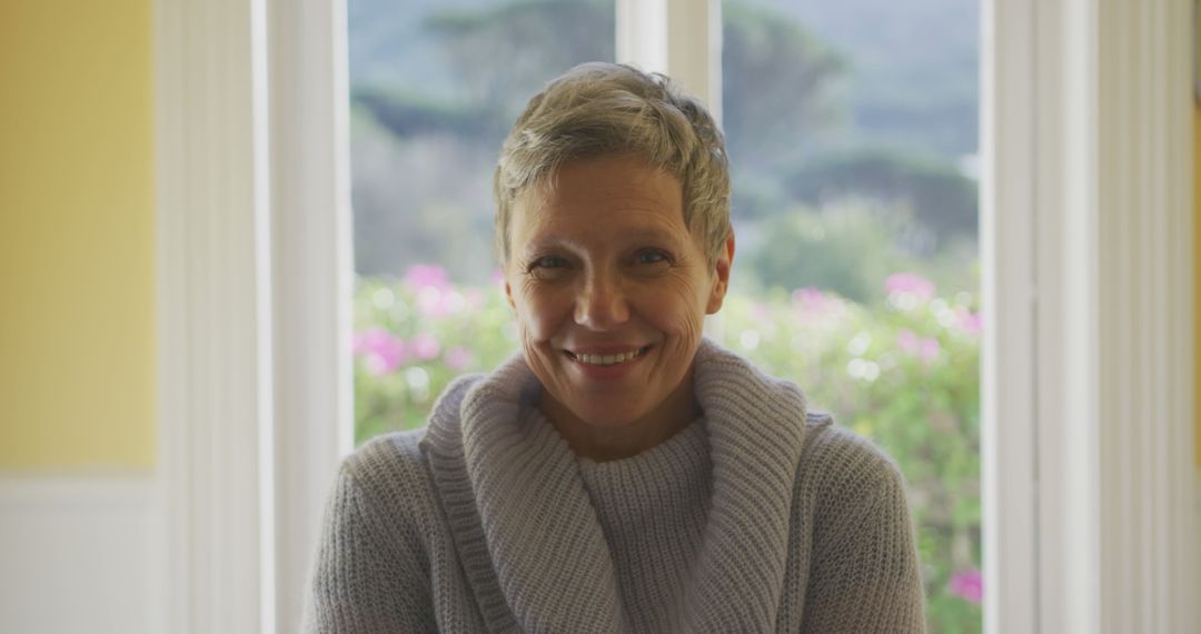 Smiling woman with short hair wearing a cozy sweater indoors - Free Images, Stock Photos and Pictures on Pikwizard.com