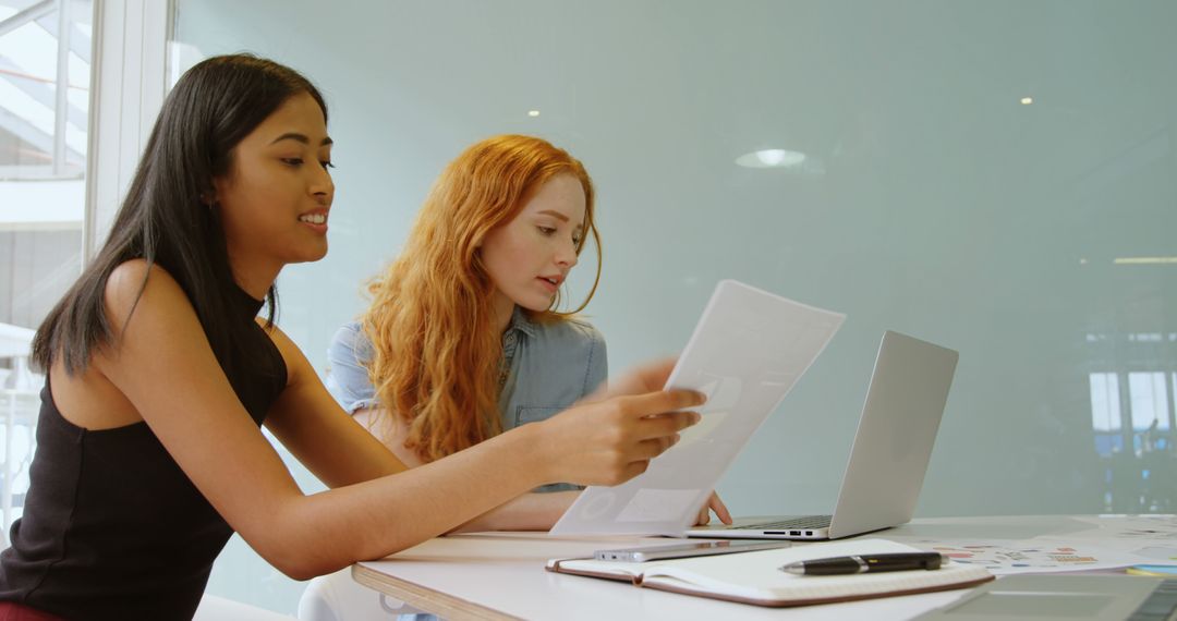 Two Women Collaborating on Business Project in Modern Office - Free Images, Stock Photos and Pictures on Pikwizard.com