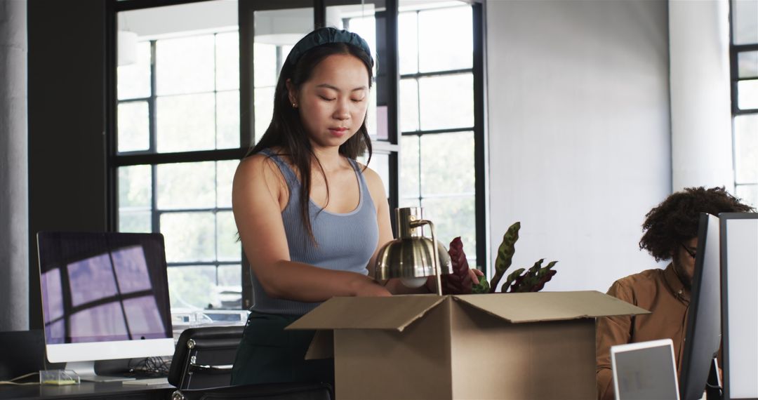 Young Professionals Unpacking in Modern Office Environment