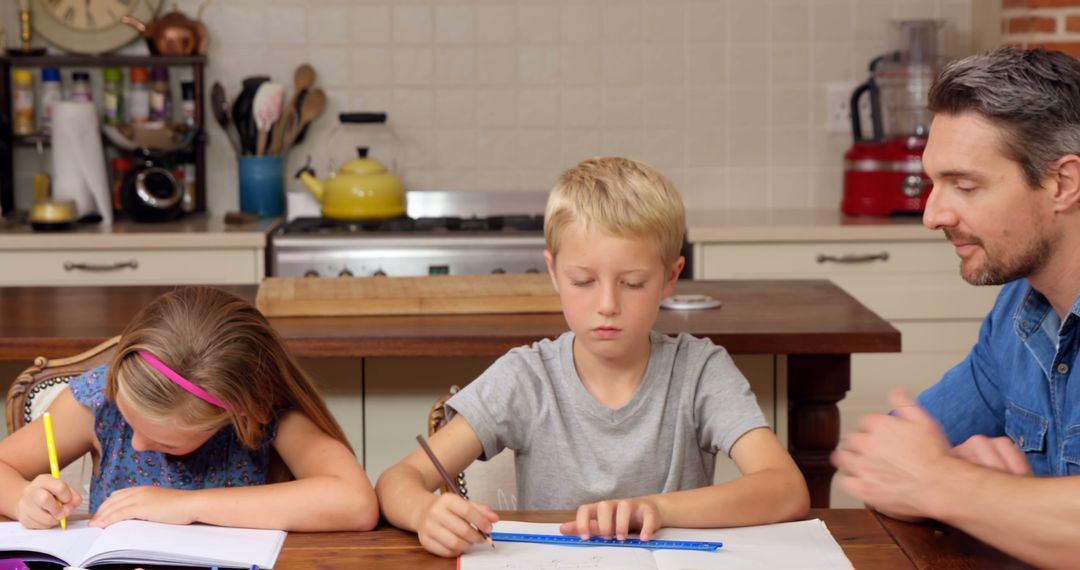 Father Helping His Children with Homework at Kitchen Table - Free Images, Stock Photos and Pictures on Pikwizard.com