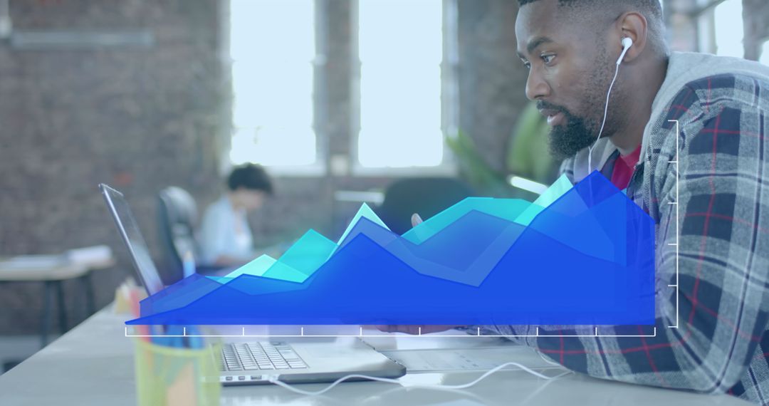 Focused Professional Analyzing Data on Laptop with Graphical Overlay