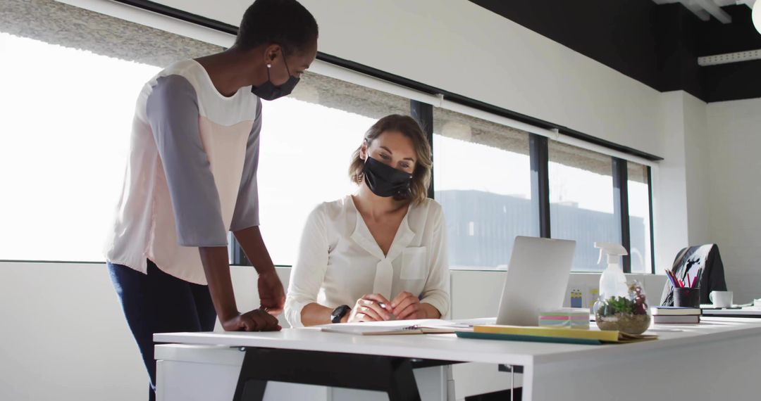 Colleagues Collaborating with Masks in Modern Office Environment