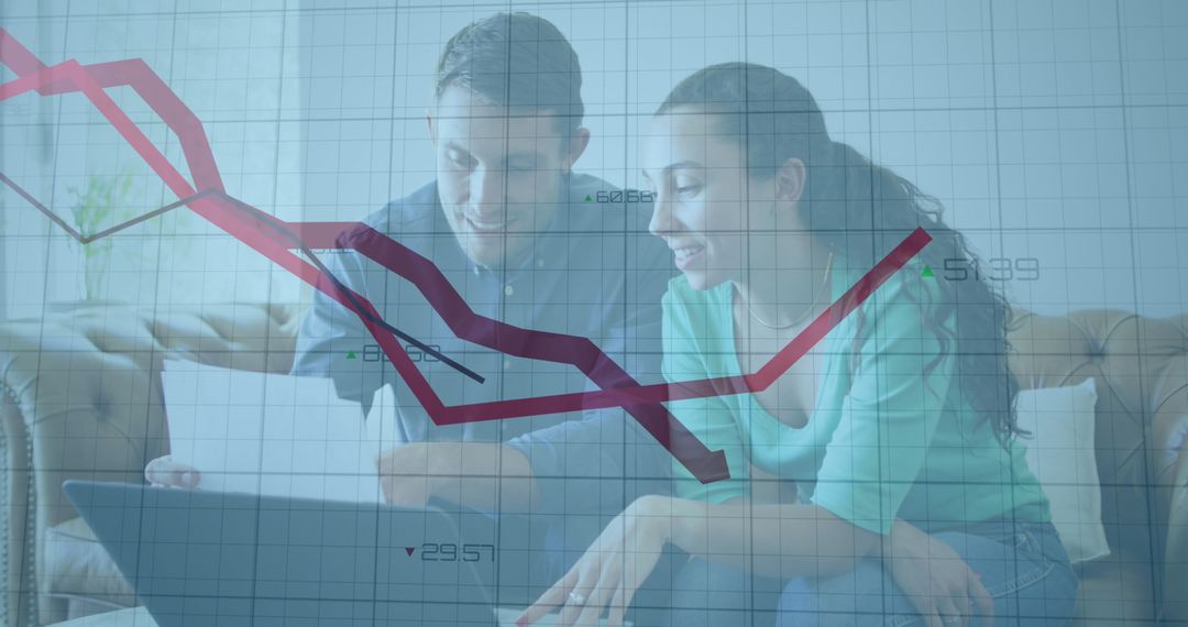 Smiling Couple Analyzing Graph Data on Laptop Screen