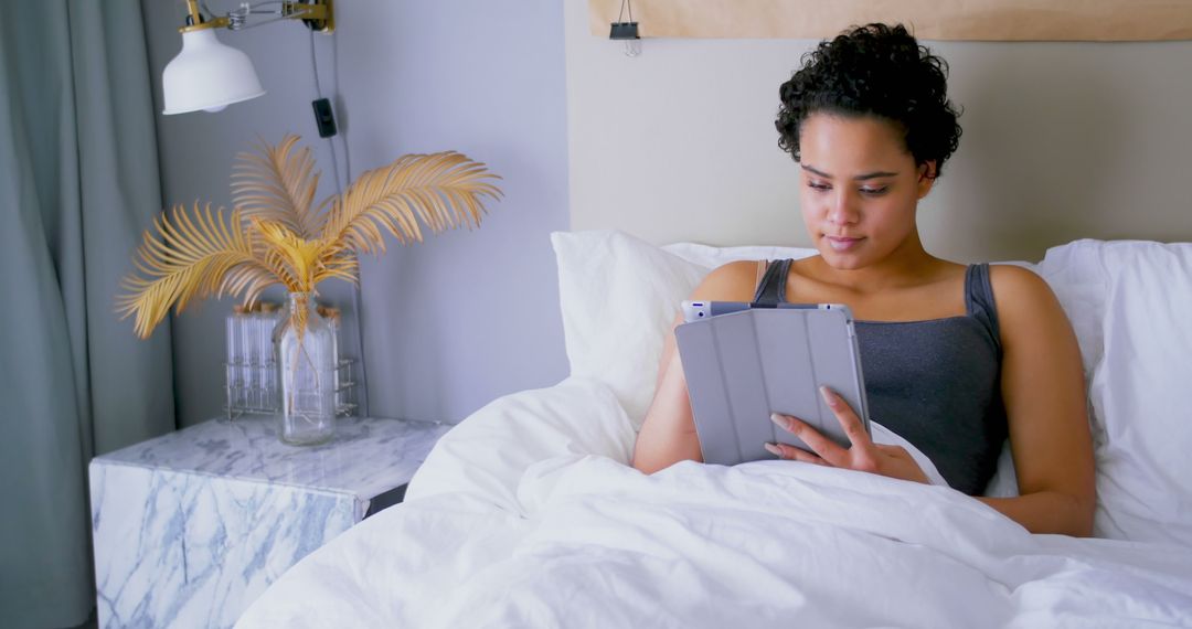 Woman Relaxing in Bed while Using Digital Tablet - Free Images, Stock Photos and Pictures on Pikwizard.com