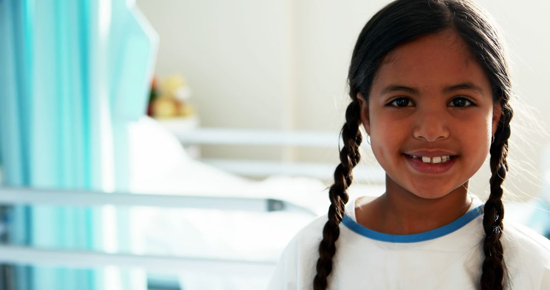 Smiling Girl with Braids in Hospital Room - Free Images, Stock Photos and Pictures on Pikwizard.com