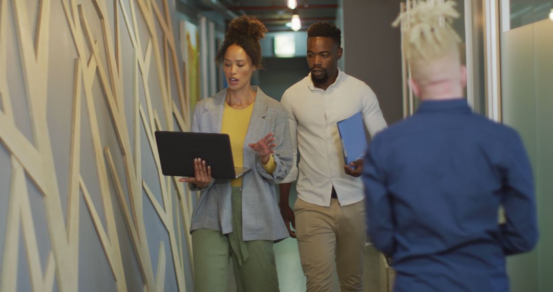 Business Team Collaborating While Walking in Modern Office