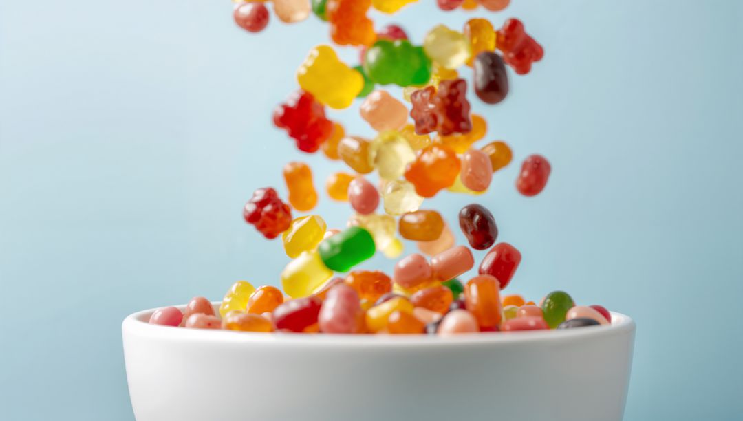 Gummy Bears and Jelly Beans Pouring into Bowl