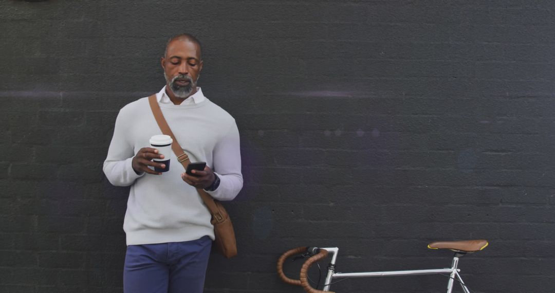 African American Man Commuting with Smartphone and Coffee