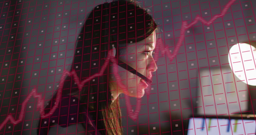 Businesswoman Analyzing Computer with Financial Graph Overlay