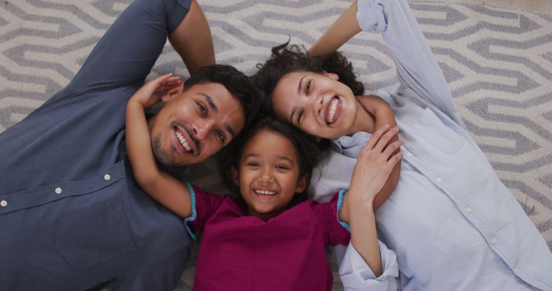 Smiling Family Lying on Carpet at Home - Free Images, Stock Photos and Pictures on Pikwizard.com