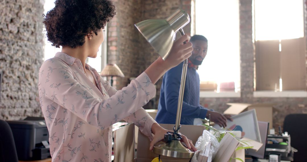 Colleagues Unpacking Boxes During Office Relocation