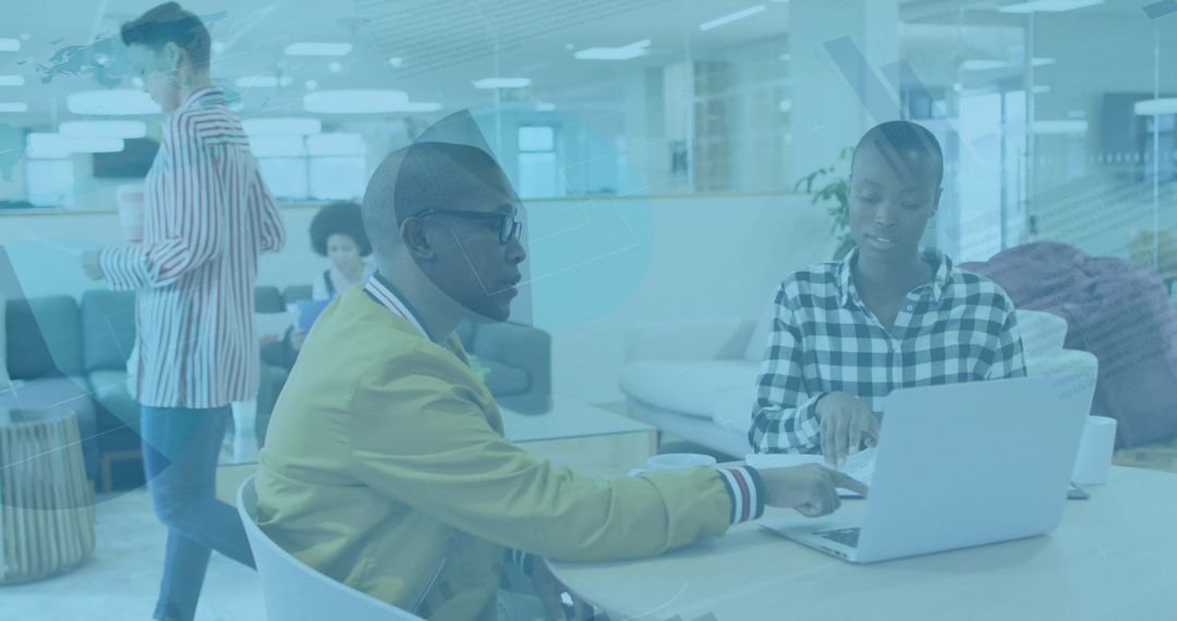 Modern Coworking Environment with Colleagues Collaborating on Laptop