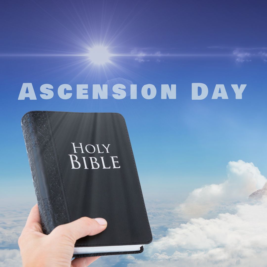 Bible in Hand Represents Ascension Day with Heavenly Background