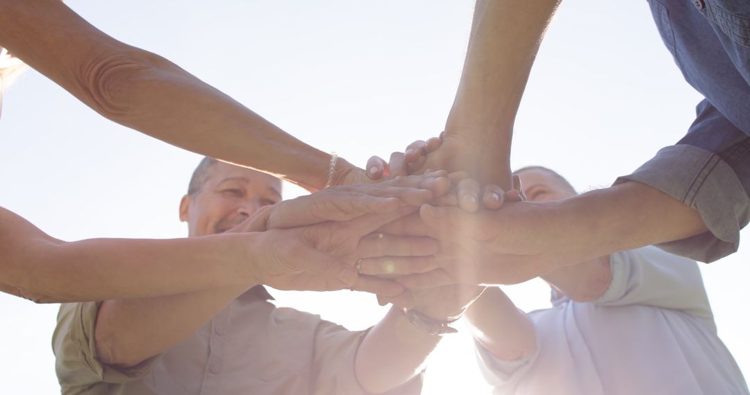 Diverse Family Stacking Hands in Supportive Circle