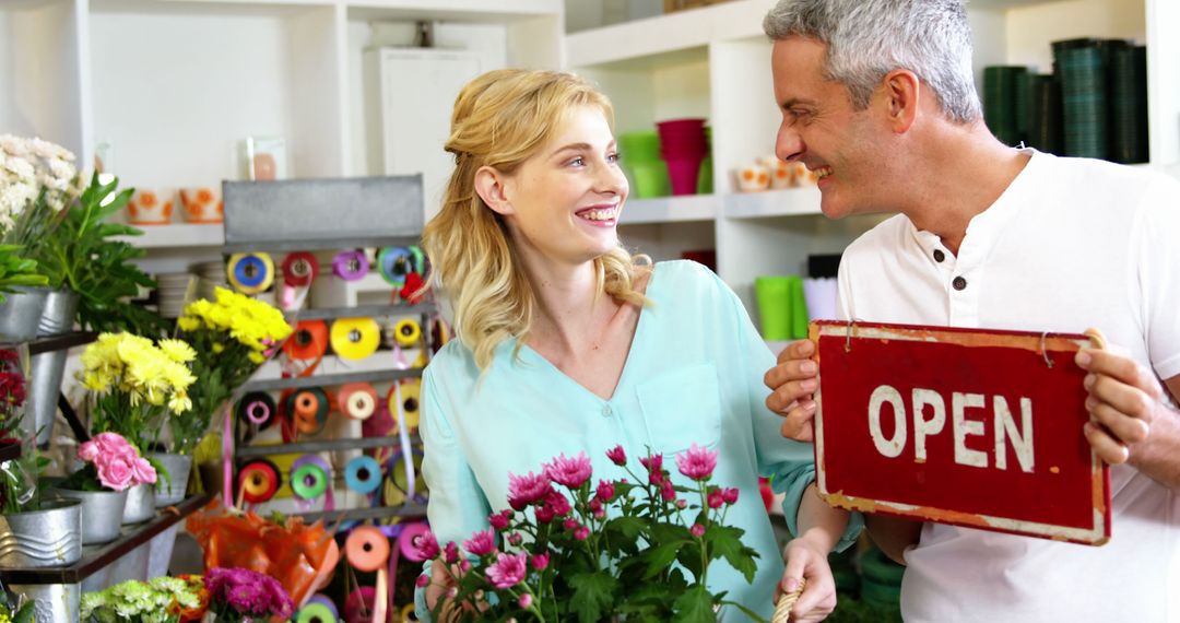 Smiling Florist Couple Holding Open Sign Inside Flower Shop - Free Images, Stock Photos and Pictures on Pikwizard.com