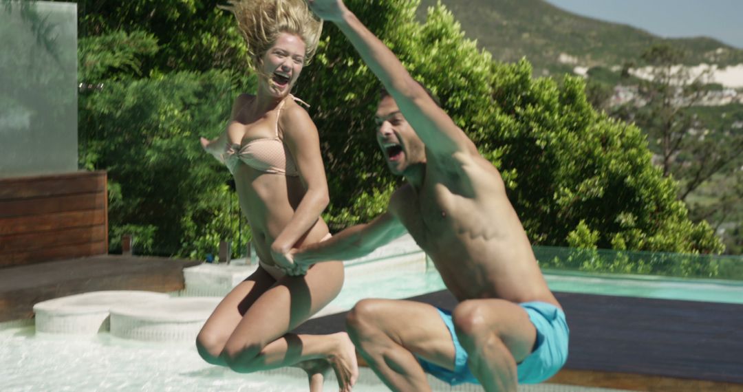 Young Couple Jumping into Pool Having Fun during Summer - Free Images, Stock Photos and Pictures on Pikwizard.com