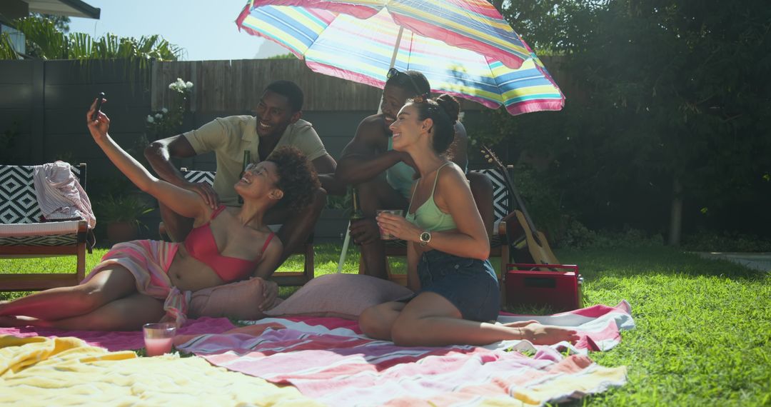 Friends Taking Selfie During Relaxed Backyard Picnic