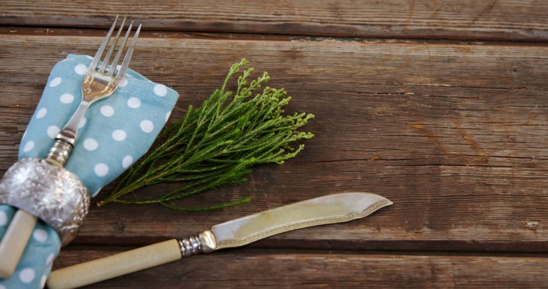 Rustic Table Setting with Polka Dot Napkin and Greenery