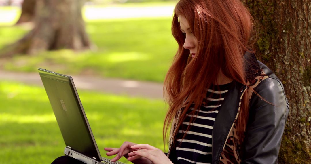 Young Woman Using Laptop Outdoors in Park - Free Images, Stock Photos and Pictures on Pikwizard.com