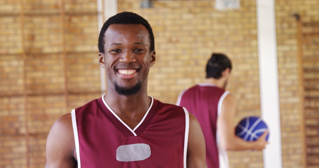 Smiling Basketball Player Wearing Maroon Jersey - Free Images, Stock Photos and Pictures on Pikwizard.com