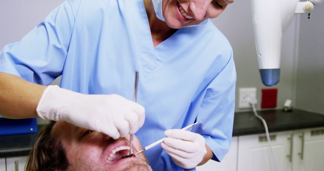 Dentist Treating Patient in Dental Office - Free Images, Stock Photos and Pictures on Pikwizard.com